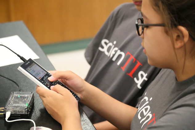 A stduent using a calculator with the TI-Innovator Hub